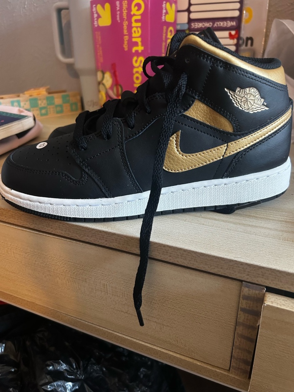 Air Jordan 1 Black and Gold Mid-Top Sneaker